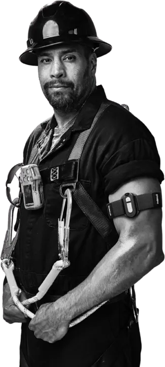 Worker in a hard hat and fall-arrest harness wearing an Epicore armband on the upper arm