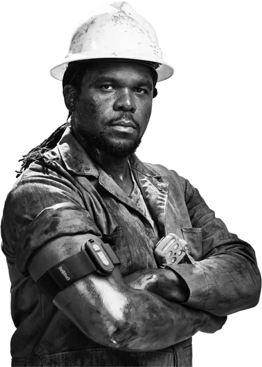 Worker in a white hard hat with arms crossed, wearing an Epicore armband