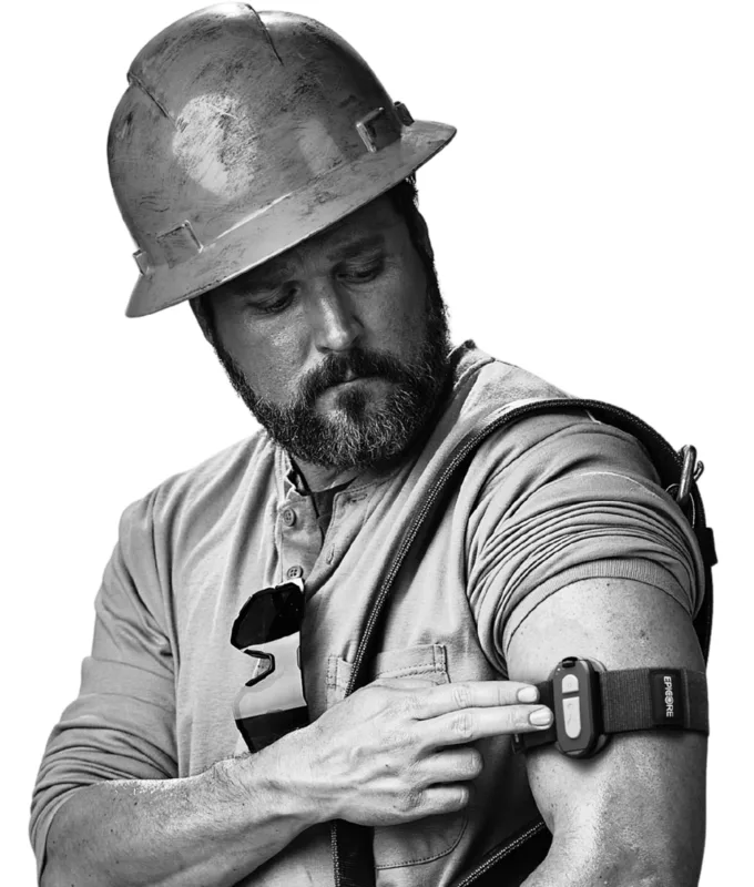 Worker pressing the button on the Epicore module worn on their upper arm